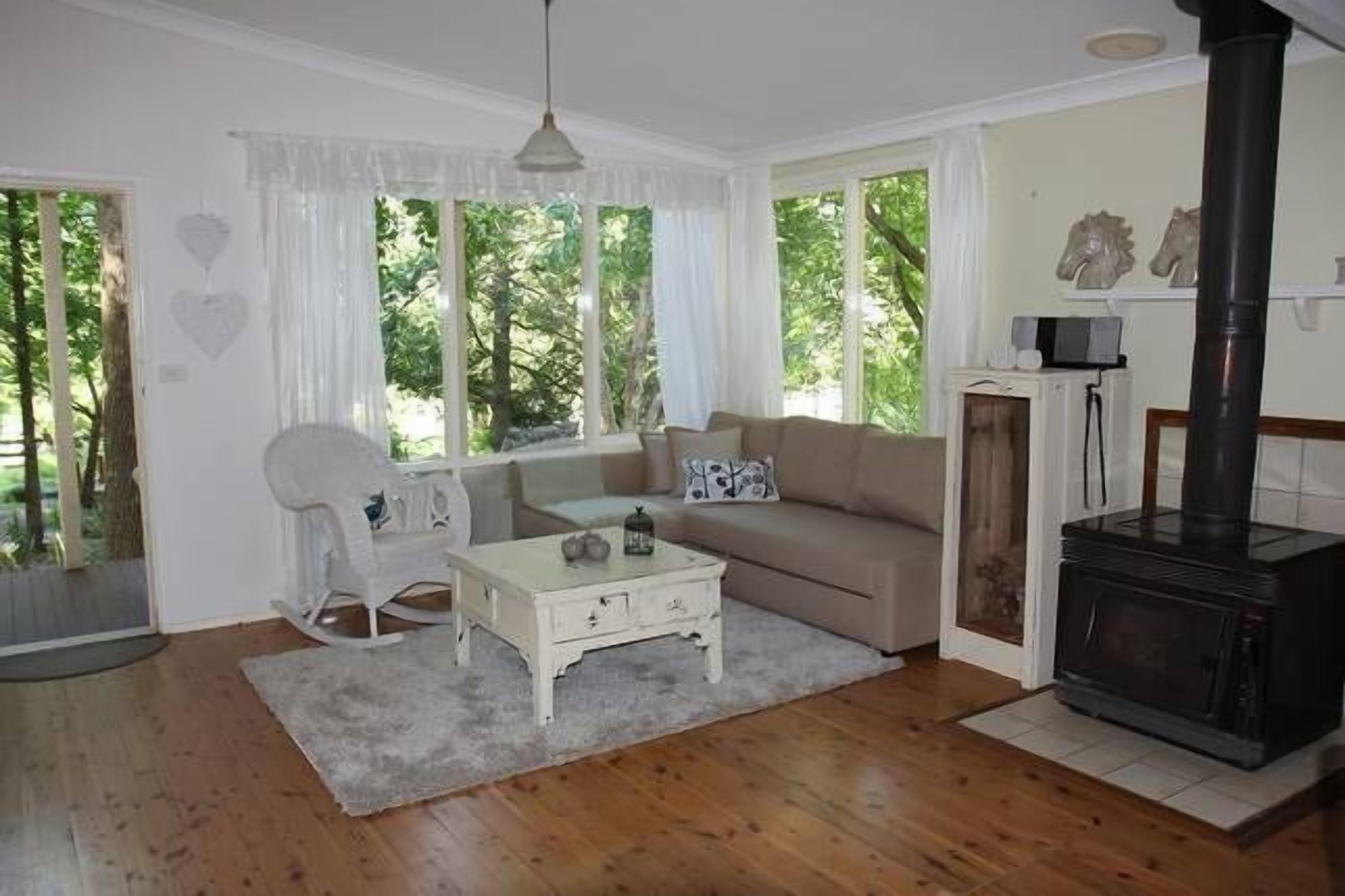 Living room with wood fire and garden views
