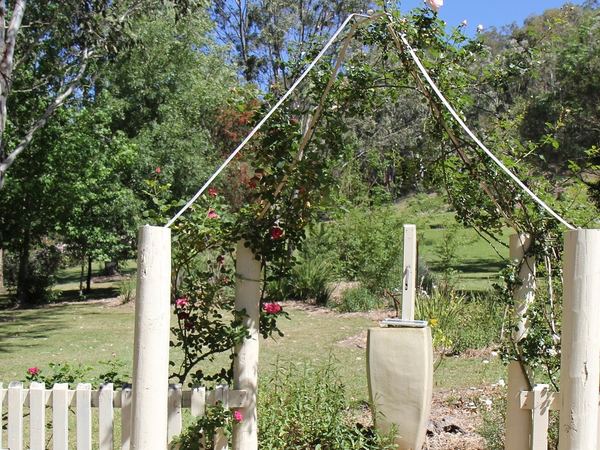 White picket gate and arch leading into the garden